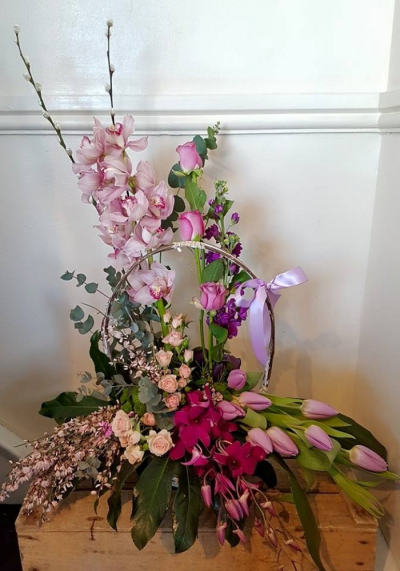 Floral Extravagance - Orchid, Lilies, lush roses, willow and blossoms of the season with foliage to compliment