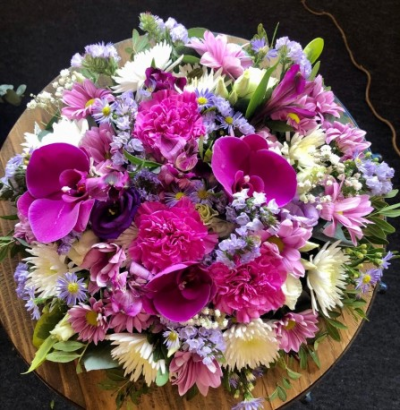 Traditional Posy Pad - This traditional posy pad in the florist choice mix of pinks, purples, creams and whites with delicate green foliage. 

Available in 4 different sizes; 12" (please call), 14", 16" and 18".

Each arrangement is designed and created by the talented florists at Flowers of Kidderminster. Professional, qualified, local florists, Emma and her team put together each arrangement by hand, from scratch, from the wide selection of beautiful fresh flowers here in our shop on Lisle Avenue.

Each tribute is designed and expertly prepared by professional, locally based, florists Emma and Laura. At this difficult time, Emma and her team are here to help make choosing and ordering funeral flowers and sympathy tributes a little easier.

All arrangements are created from our collection of fresh flowers at our shop in Lisle Avenue, Kidderminster.

Almost what you're after? We tailor all funeral tributes to your specific requirements. We can incorporate their favourite colours or create a style that reflects their personality. Come in and talk to us about what you would like and we will create it for you.

All flowers are subject to availability. Substitutes may be used but your tribute will always look beautiful!

Funeral Tributes can be delivered on the day to a location of your choice