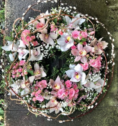Loose orchid and rose wreath - Funeral Tributes which reflect the personality and the life of the person sadly departed are created with care and attention by our team of qualified, professional and local florists.

This beautiful orchid and rose wreath, can be ordered in 16" and 18" and is a made up in the florists' selection of stems. Please state in your order notes if you would like different colours from those shown in the picture.

Each tribute is designed and created by professional, qualified, local florists, Emma and her team.

The talented florists at Flowers of Kidderminster add a touch of style to every bouquet, which is put together by hand, from scratch. Almost what you're after? We tailor all funeral tributes to your specific requirements. We can incorporate their favourite colours or create a style that reflects their personality. Come in and talk to us about what you would like and we will create it for you.

All flowers are subject to availability. Substitutes may be used but your tribute will always look beautiful!

Funeral Tributes can be delivered on the day to a location of your choice.