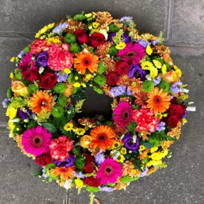 Vibrant Wreath - Funeral Tributes which reflect the personality and the life of the person sadly departed are created with care and attention by our team of qualified, professional and local florists.

This vibrant wreath, can be ordered in five different sizes; 12", 14", 16", 18" or 20" and is a made up in the florists selection of brightly coloured blooms. (For 14" and 18" please call the shop) 

Please state in your order notes if you would like different colours from those shown in the picture.

Each tribute is designed and created by professional, qualified, local florists, Emma and her team. The talented florists at Flowers of Kidderminster add a touch of style to every bouquet, which is put together by hand, from scratch.

Almost what you're after? We tailor all funeral tributes to your specific requirements. We can incorporate their favourite colours or create a style that reflects their personality. Come in and talk to us about what you would like and we will create it for you.

All flowers are subject to availability. Substitutes may be used but your tribute will always look beautiful!

Funeral Tributes can be delivered on the day to a location of your choice.