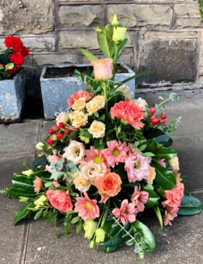 Traditional Posy - Sympathy flowers are a beautiful way to let someone know that you are thinking of them at a sad time.

This traditional style posy includes florist selected fresh stems with pastel peach blooms including roses and carnations alongside berries set within delicate green foliage. 

Each tribute is designed and created by professional, qualified, local florists, Emma and her team. At this difficult time, they are here to help make choosing and ordering funeral flowers and sympathy tributes a little easier.

Almost what you're after? We can tailor your tribute to suit your needs and budget. Want to incorporate their favourite colours? All colours, styles and budgets can all be catered for.

All flowers are subject to availability. Substitutes may be used but your tribute will always look beautiful!

Order by 2pm for same day delivery. Also available to order for a day of your choice.