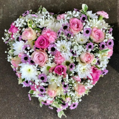 Mixed Bloom Heart - This Mixed Bloom Heart funeral tribute can be made with single colour blooms or a mixture of colours.

Available in three different sizes: 13" or 15".

You may also like to look at our Heart of Roses and Clustered Open Heart tributes.

Funeral Tributes are created with care and attention by our team of qualified, professional and local florists Emma and her team. 

Almost what you're after? We tailor all funeral tributes to your specific requirements. We can incorporate their favourite colours or create a style that reflects their personality. Call us to talk about what you would like and we will create it for you.

All flowers are subject to availability. Substitutes may be used but your tribute will always look beautiful!

Funeral Tributes can be delivered on the day to a location of your choice.
