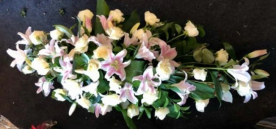 Lilies and Roses Coffin Spray White and Pale Pink - This double-ended spray is a made up in the florists' selection of pale pink and cream stems can be made in 3ft, 4ft or 5ft lengths. 

Also available in a variety of colours or as a single colour arrangement.

Each tribute is designed and expertly prepared by professional, locally based, florists Emma and Laura. At this difficult time, Emma and her team are here to help choosing and ordering funeral flowers and sympathy tributes a little easier.

All arrangements are created from our collection of fresh flowers at our shop in Lisle Avenue, Kidderminster.

Almost what you're after? We tailor all funeral tributes to your specific requirements. We can incorporate their favourite colours or create a style that reflects their personality. Come in and talk to us about what you would like and we will create it for you.

All flowers are subject to availability. Substitutes may be used but your tribute will always look beautiful!

Funeral Tributes can be delivered on the day to a location of your choice.