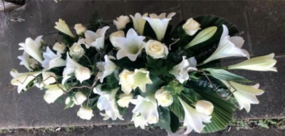 Lilies and Roses Coffin Spray White - This double-ended spray is a made up in the florists' selection of white stems can be made in 3ft, 4ft or 5ft lengths. 

Also available in a variety of colours or as a single colour arrangement.

Each tribute is designed and expertly prepared by professional, locally based, florists Emma and Laura. At this difficult time, Emma and her team are here to help choosing and ordering funeral flowers and sympathy tributes a little easier.

All arrangements are created from our collection of fresh flowers at our shop in Lisle Avenue, Kidderminster.

Almost what you're after? We tailor all funeral tributes to your specific requirements. We can incorporate their favourite colours or create a style that reflects their personality. Come in and talk to us about what you would like and we will create it for you.

All flowers are subject to availability. Substitutes may be used but your tribute will always look beautiful!

Funeral Tributes can be delivered on the day to a location of your choice.