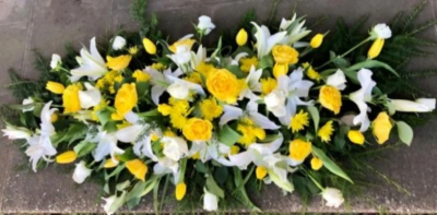 Lilies and Roses Coffin Spray Yellow and White - This double-ended spray is a made up in the florists' selection of yellow and white stems can be made in 3ft, 4ft or 5ft lengths. 

Also available in a variety of colours or as a single colour arrangement.

Each tribute is designed and expertly prepared by professional, locally based, florists Emma and Laura. At this difficult time, Emma and her team are here to help choosing and ordering funeral flowers and sympathy tributes a little easier.

All arrangements are created from our collection of fresh flowers at our shop in Lisle Avenue, Kidderminster.

Almost what you're after? We tailor all funeral tributes to your specific requirements. We can incorporate their favourite colours or create a style that reflects their personality. Come in and talk to us about what you would like and we will create it for you.

All flowers are subject to availability. Substitutes may be used but your tribute will always look beautiful!

Funeral Tributes can be delivered on the day to a location of your choice.