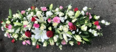 Lilies & Roses Coffin Spray in Red, Pink and White - This double-ended spray is a made up in the florists' selection of red, pink, cream and white stems can be made in 3ft, 4ft or 5ft lengths.

Also available in a variety of colours or as a single colour arrangement.

Each tribute is designed and expertly prepared by professional, locally based, florists Emma and Laura. At this difficult time, Emma and her team are here to help choosing and ordering funeral flowers and sympathy tributes a little easier.

All arrangements are created from our collection of fresh flowers at our shop in Lisle Avenue, Kidderminster. Almost what you're after? We tailor all funeral tributes to your specific requirements. We can incorporate their favourite colours or create a style that reflects their personality.

Come in and talk to us about what you would like and we will create it for you.

All flowers are subject to availability. Substitutes may be used but your tribute will always look beautiful!

Funeral Tributes can be delivered on the day to a location of your choice.