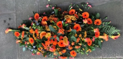 Autumnal Coffin Spray - This warm double-ended coffin spray is made up in the florists' selection of autumnal coloured stems including Roses, Cala Lilies, Gerberas and Carnations against rich green foliage and is available in 4 different lengths; 3ft (please call), 4ft, 5ft or 6ft.

Funeral Tributes which reflect the personality and the life of the person sadly departed are created with care and attention by our team of qualified, professional and local florists.

Express condolences and pay tribute with this spray, expertly prepared by professional, locally based, florists Emma and Laura. At this difficult time, Emma and her team are here to help make choosing and ordering funeral flowers and sympathy tributes a little easier.

All arrangements are created from our collection of fresh flowers at our shop in Lisle Avenue, Kidderminster. 

Almost what you're after? We tailor all funeral tributes to your specific requirements. We can incorporate their favourite colours or create a style that reflects their personality. Come in and talk to us about what you would like and we will create it for you.

All flowers are subject to availability. Substitutes may be used but your tribute will always look beautiful!

Funeral Tributes can be delivered on the day to a location of your choice.
