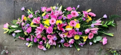 Pink and Yellow Coffin Spray - This pink and yellow, double-ended coffin spray is made up in the florists' selection of stems including Roses and Carnations against green foliage and is available in 2 different lengths; 4ft or 5ft.

Funeral Tributes which reflect the personality and the life of the person sadly departed are created with care and attention by our team of qualified, professional and local florists.

Express condolences and pay tribute with this spray, expertly prepared by professional, locally based, florists Emma and Laura. At this difficult time, Emma and her team are here to help make choosing and ordering funeral flowers and sympathy tributes a little easier.

All arrangements are created from our collection of fresh flowers at our shop in Lisle Avenue, Kidderminster. 

Almost what you're after? We tailor all funeral tributes to your specific requirements. We can incorporate their favourite colours or create a style that reflects their personality. Come in and talk to us about what you would like and we will create it for you.

All flowers are subject to availability. Substitutes may be used but your tribute will always look beautiful!

Funeral Tributes can be delivered on the day to a location of your choice.