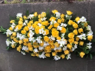 Rose and Freesia Coffin Spray - This all rose and freesia double-ended coffin spray in yellow and white is available in 4f or 5ft lengths

Funeral Tributes which reflect the personality and the life of the person sadly departed are created with care and attention by our team of qualified, professional and local florists.

Express condolences and pay tribute with this spray, expertly prepared by professional, locally based, florists Emma and Laura. At this difficult time, Emma and her team are here to help make choosing and ordering funeral flowers and sympathy tributes a little easier.

All arrangements are created from our collection of fresh flowers at our shop in Lisle Avenue, Kidderminster. 

Almost what you're after? We tailor all funeral tributes to your specific requirements. We can incorporate their favourite colours or create a style that reflects their personality. Come in and talk to us about what you would like and we will create it for you.

All flowers are subject to availability. Substitutes may be used but your tribute will always look beautiful!

Funeral Tributes can be delivered on the day to a location of your choice.