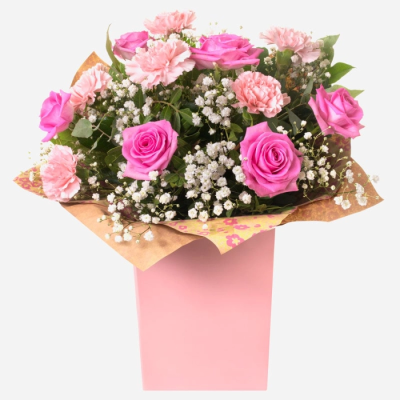Roses and ruffles - A timeless mix of pink Roses and Carnations. Beautifully presented